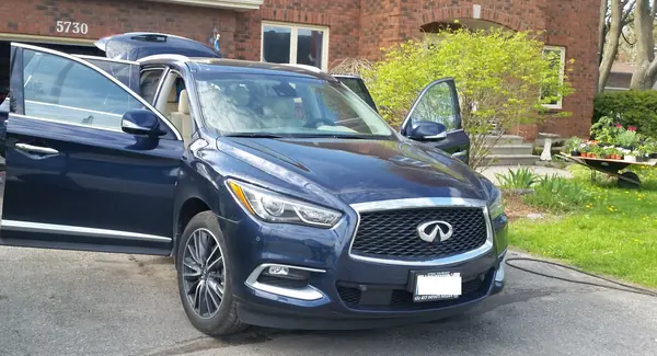 Freshly detailed blue SUV parked on a residential street