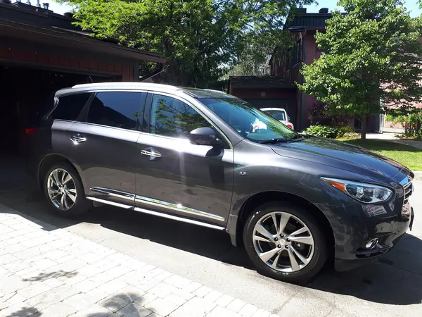 Hand-detailed SUV, side view, in a driveway