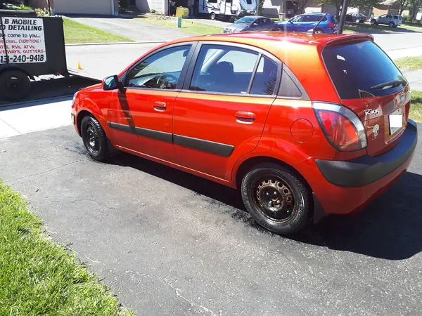 Detailed red hatchback parked on a driveway