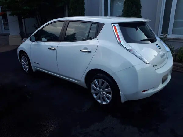 Detailed white hatchback, rear three-quarter view