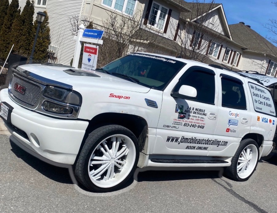 A navy SUV detailed by hand, parked in a residential driveway in Ottawa
